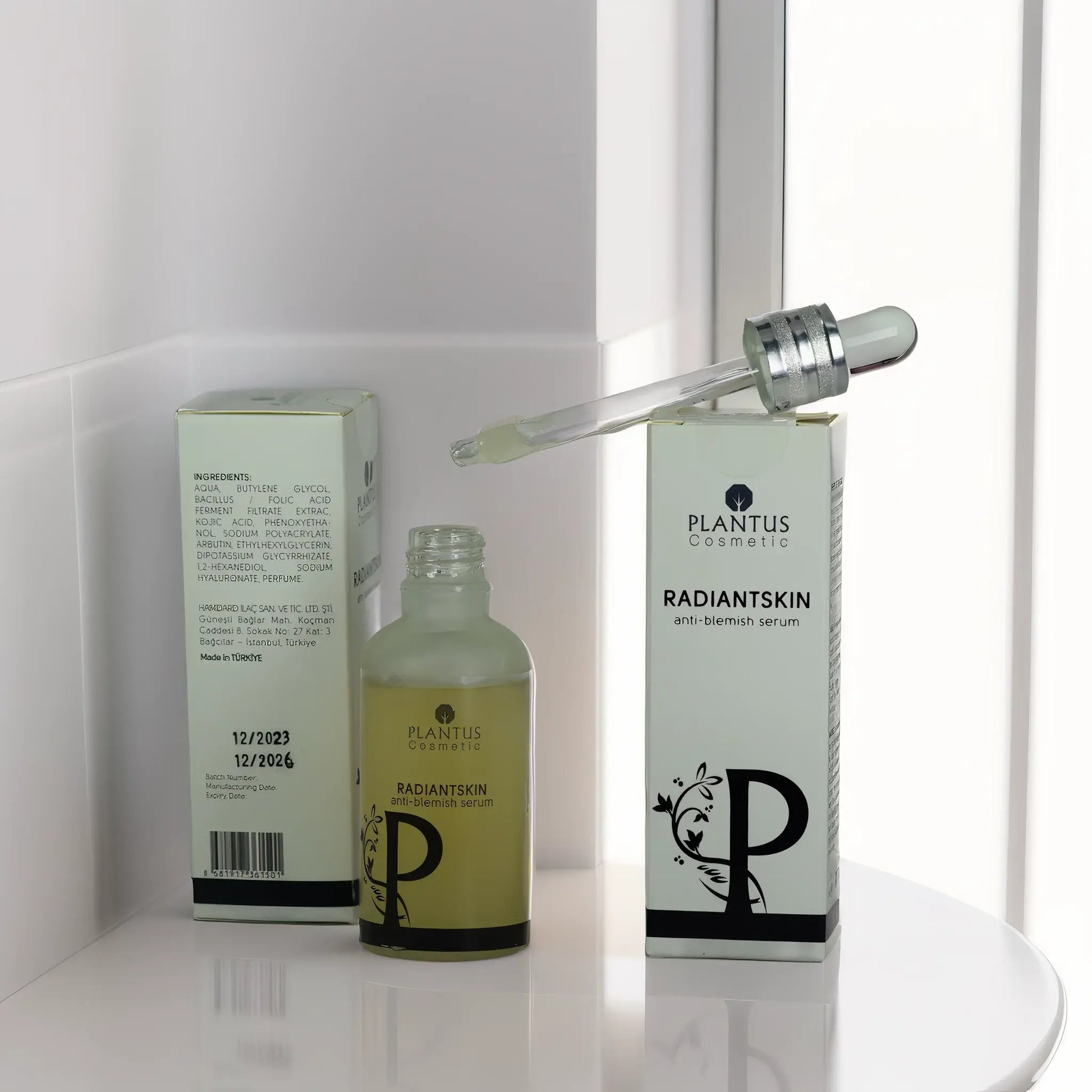 Plantus Radiant Skin Anti-Blemish Serum bottle and box displayed on a surface, featuring their label and droplet applicator.