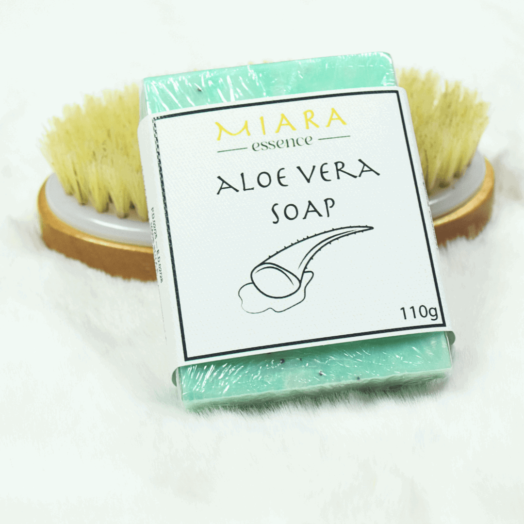 Miara Essence Aloe Vera Natural Soap on a soft surface next to a brush, showcasing its soothing properties.
