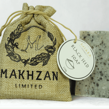 Black Seed Natural Soap by Miara Essence displayed with packaging in a natural burlap bag.