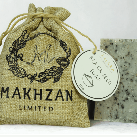 Black Seed Natural Soap by Miara Essence displayed with packaging in a natural burlap bag.