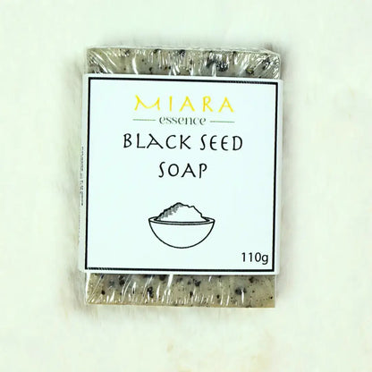 Miara Essence Black Seed Natural Soap bar wrapped in clear plastic, showcasing its earthy texture and branding.