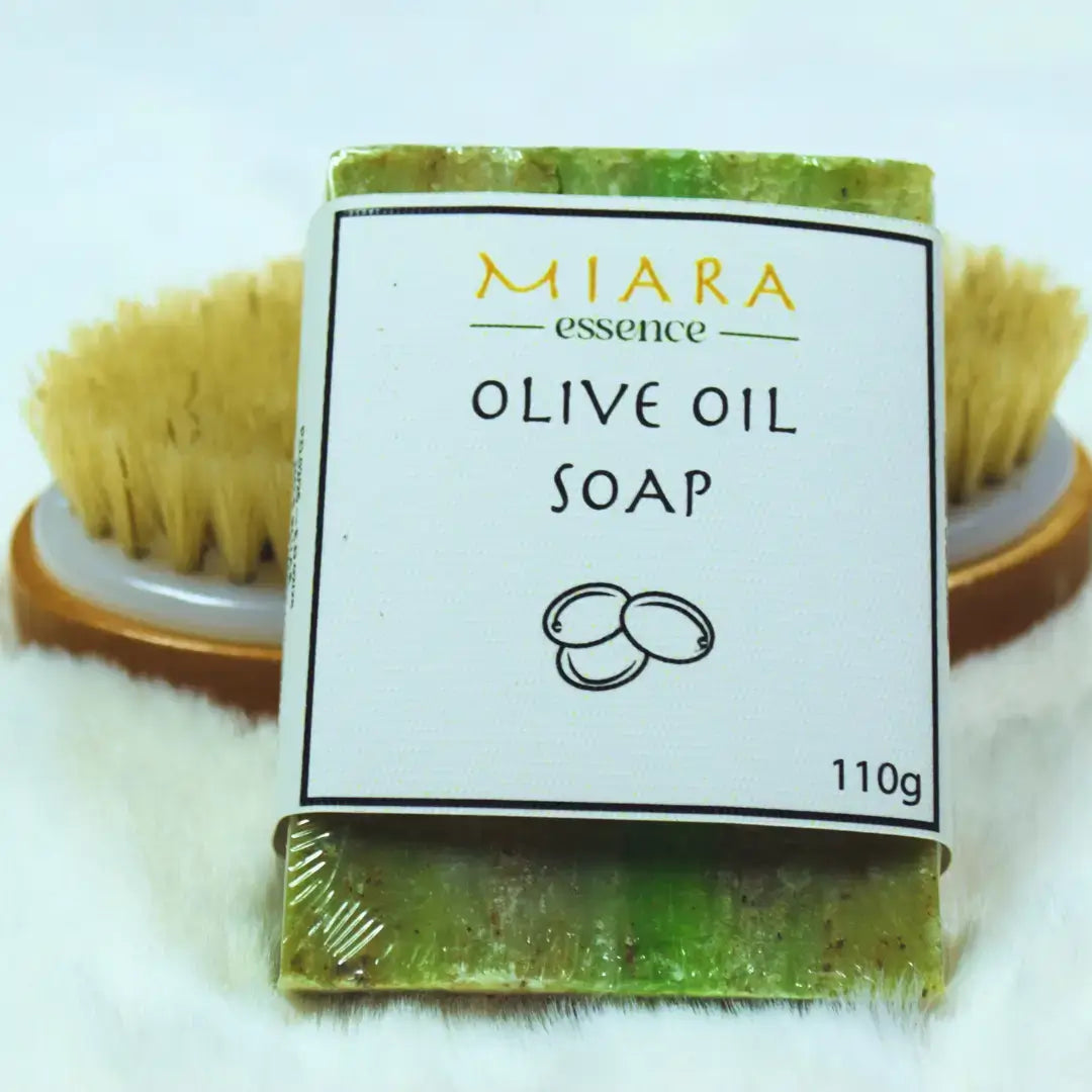 Natural Olive Oil Soap | Miara Essence Pure Olive Oil Soap with a brushing tool in the background.